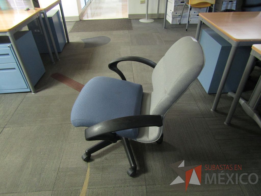 Lote 123 - Silla operativa con ruedas, descansabrazos fijo, asiento y respaldo en tela color azul con gris. ( En mal estado.) - Imagen 8